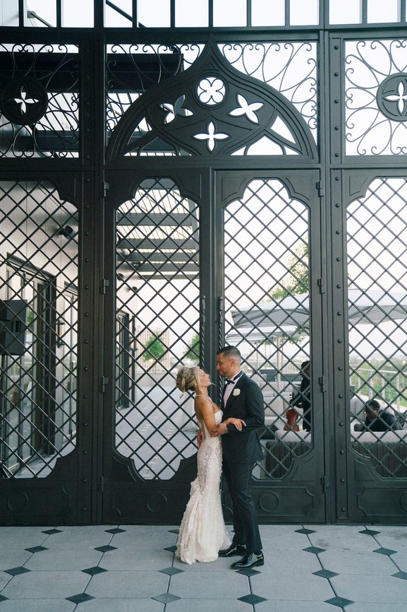 Wedding Couple in Front Of Patio Entrance Houston Weddings